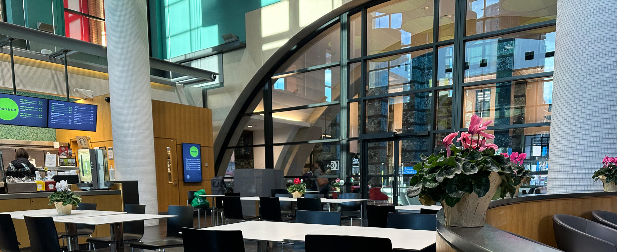 From inside the Café at the City of Mississauga’s City Hall, on a clear sunny day, showing the reflection of the outside buildings on the inner windows.